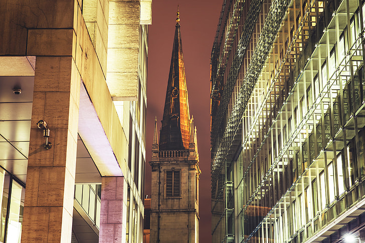 Church spire surrounded by modern buildings in London