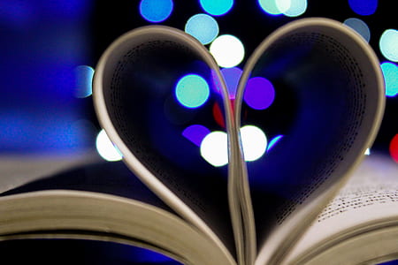 Photo of Bookpages Folded Into Heart Shape With Bokeh Light Background