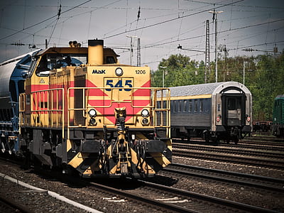 yellow and red train on rail