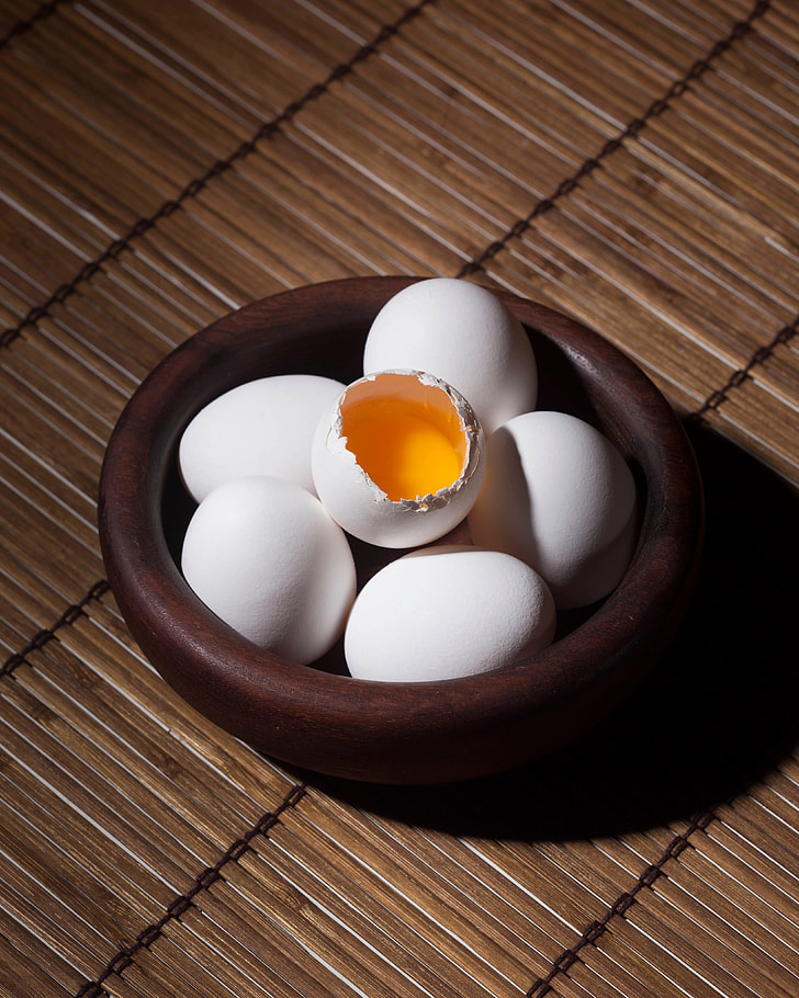 cracked egg on five eggs inside bowl