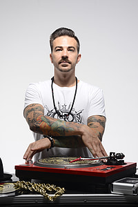man in white crew-neck t-shirt using turntable