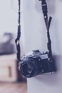 hanging black and gray Minolta camera