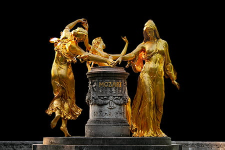 photo of three woman dancing statue