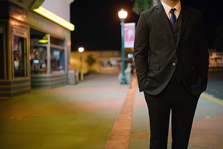 man wearing 2-piece suit set standing near building
