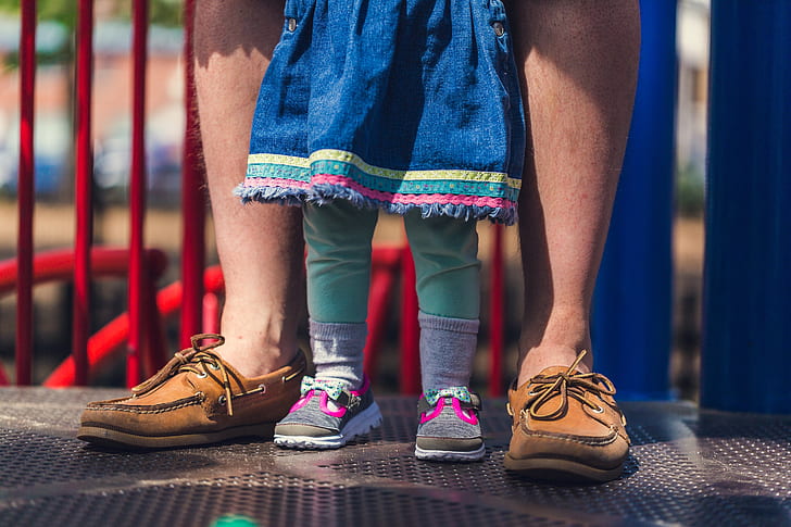 toddler wearing blue dress with teal pants and pink shoes
