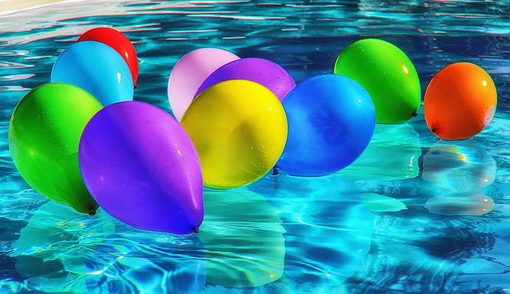 assorted-color inflated balloons floating in pool of water