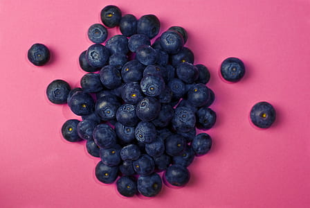 blueberries on pink surface