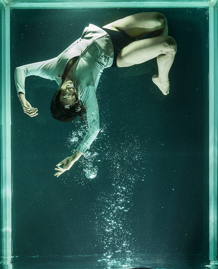 drowning person on clear glass tank