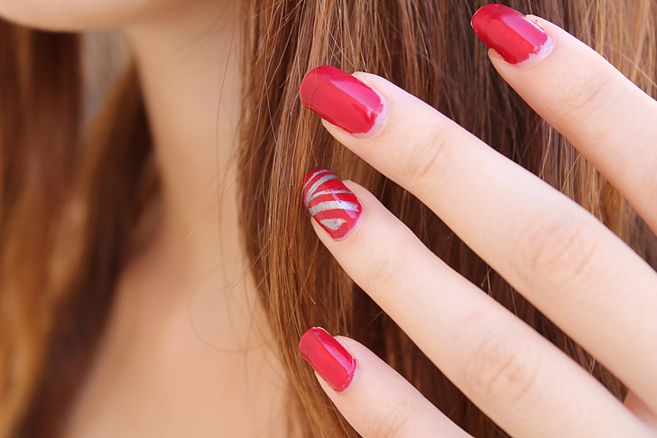 woman in red nail polish