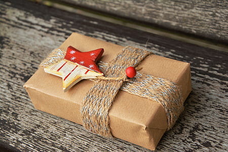brown and red gift box on brown wooden surface