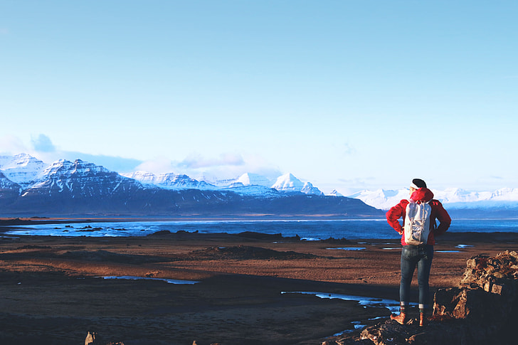 A hiker views the stunning mountains and vistas in Iceland