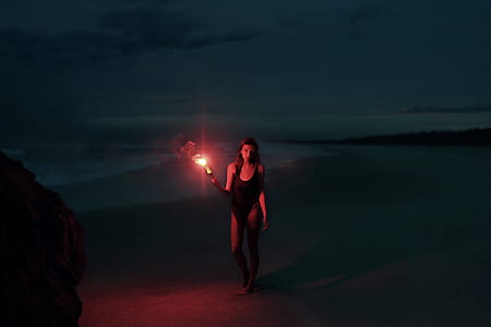 woman in black bikini holding lamp