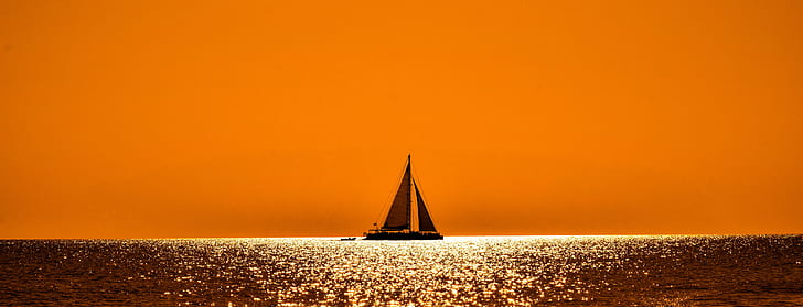 silhouette of sailing boat in the sea