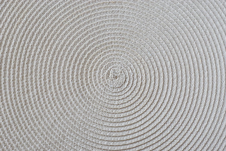 round beige woven mat in closeup photography
