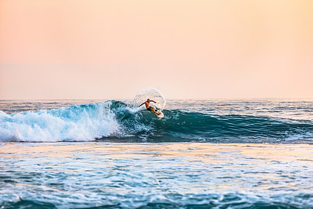 man surfing during daytime photo