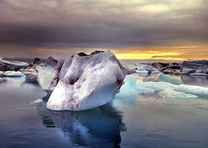 white ice berg on body of water during dawn