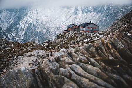 white and grey houses on top of icy mountains