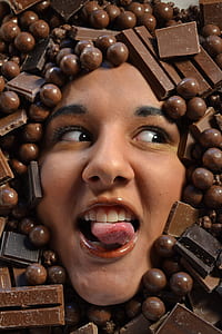 woman face surrounded by chocolates