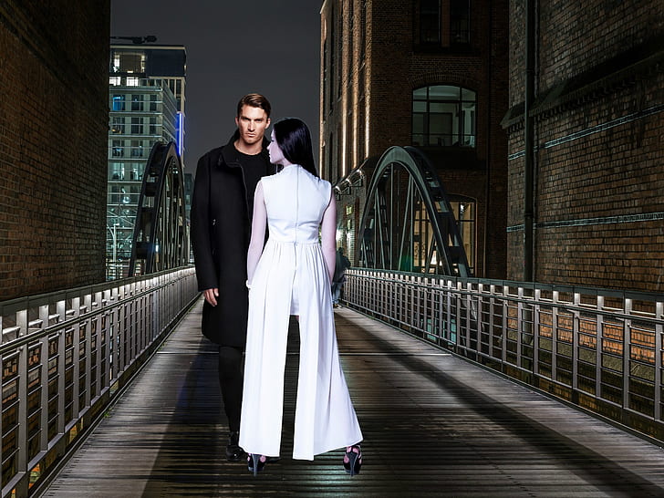 man standing on bridge with a woman in front of him