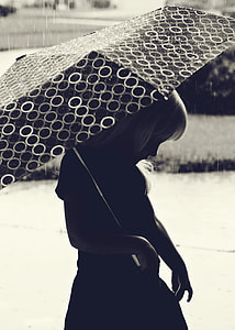 grayscale photo of girl holding umbrella