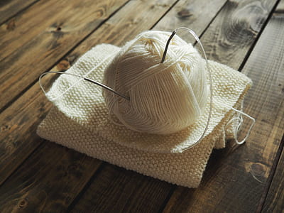 white yarn thread with needles