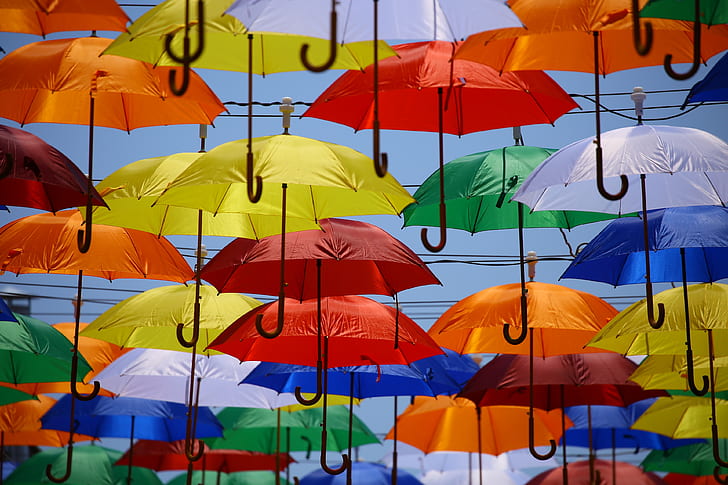 multicolored umbrellas flying on sky during daytime