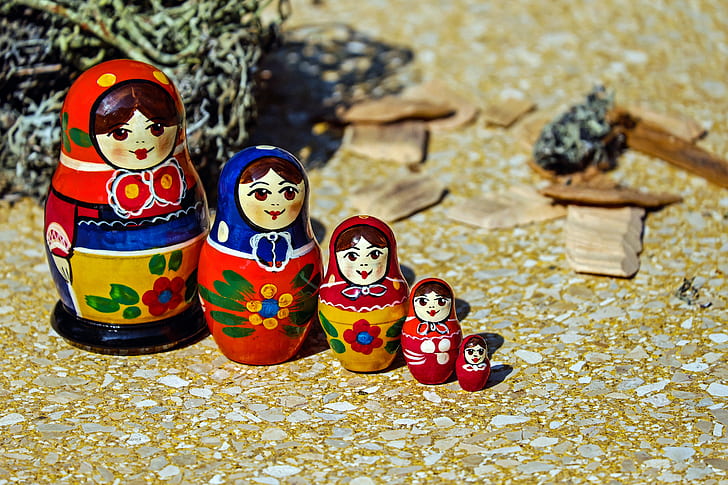 red, blue, and white floral matryoshka doll