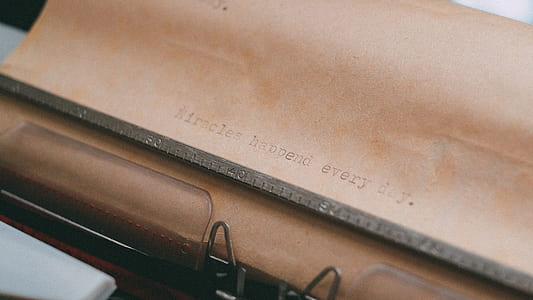selective focus photography of printed brown typewriter paper