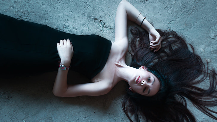 woman wearing black tube dress lying on floor