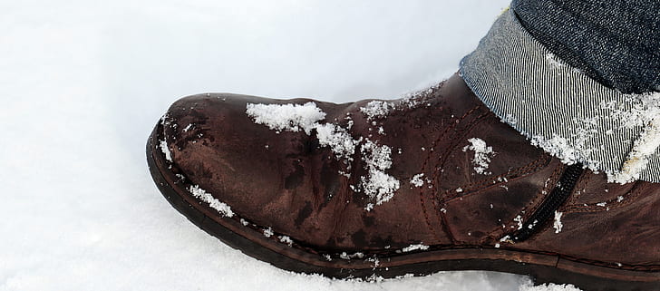 brown boot covered with snow