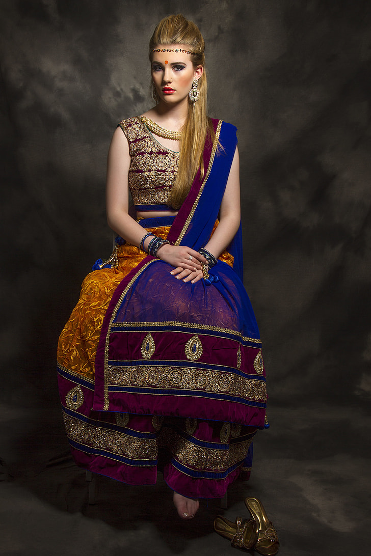 woman in multicolored sari dress sitting on chair