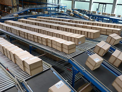 brown cardboard boxes moving along conveyor belt