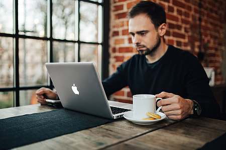 Young Entrepreneur Working from a Modern Cafe