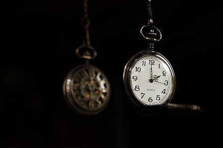 two gold-colored pocketwatch closeup photo