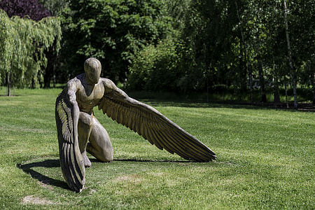 angle gray statue on green grass during daytime