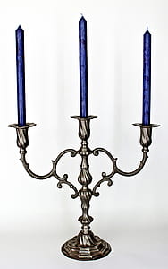 gray metal 3-candle holder with three blue unlit candles