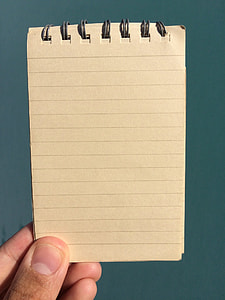 person holding black lined paper