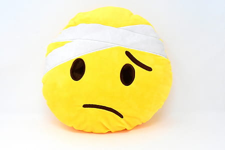 emoji plush toy on white surface