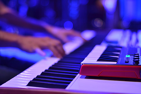 Person playing the keyboard at a music event