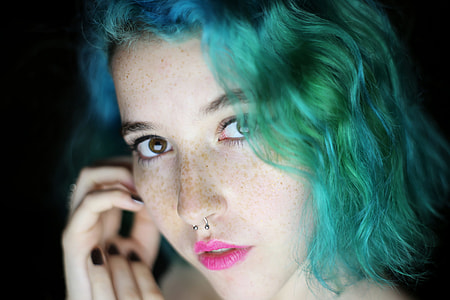 blue and green haired woman in pink lipstick