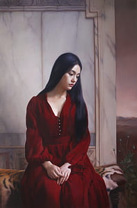woman wearing red v-neck long-sleeved dress sitting on gray brown and white textile