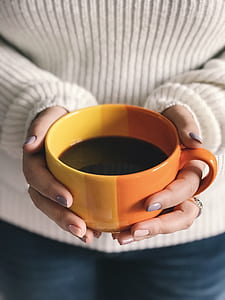person holding cup of coffee