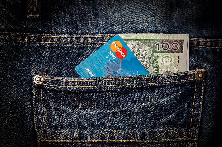 blue Mastercard card in blue denim bottoms pocket