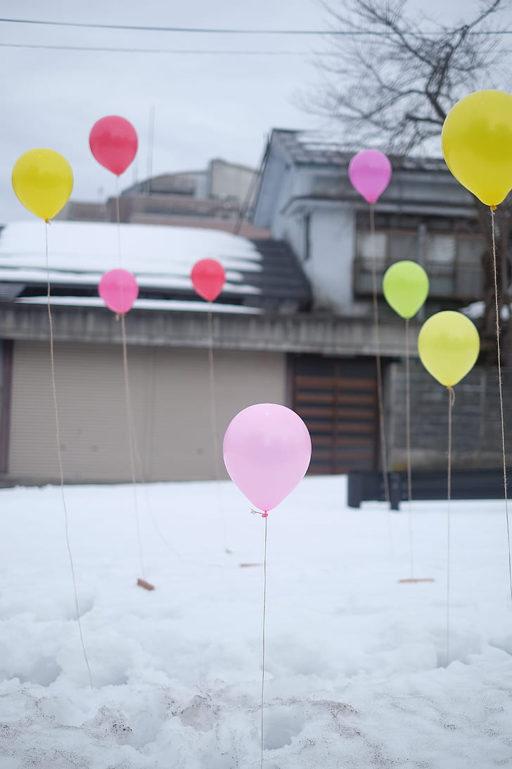 assorted-color balloons on snow covered field