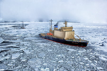 black ship on snow ice covered sea