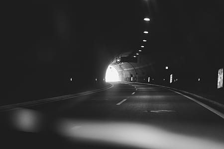 grayscale photography of tunnel