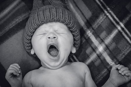 grayscale photo of baby wearing knit cap