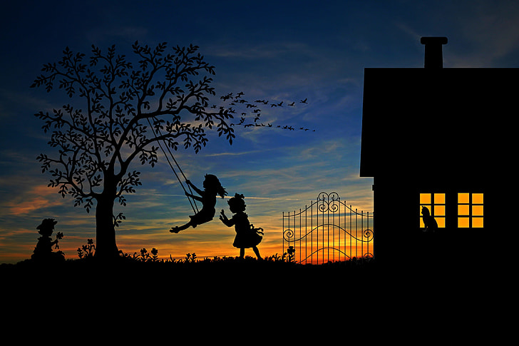 girls playing swing on tree near house silhouette