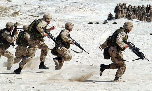 soldiers on white sand at daytime