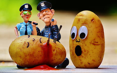 male and female police plastic figures and two potatoes